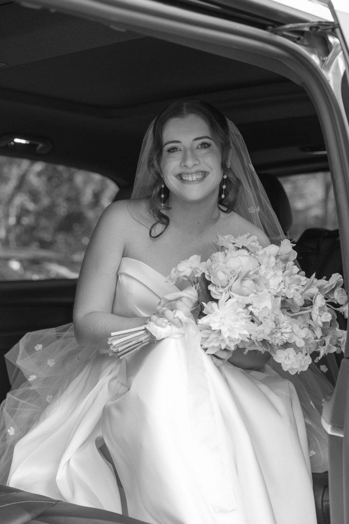 A bride laughing on her wedding day beside styling details set up by With Every Detail