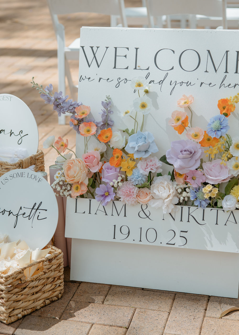 Colourful spring wedding welcome signage with poppies, stock and wattle at Bundaleer Rainforest Gardens