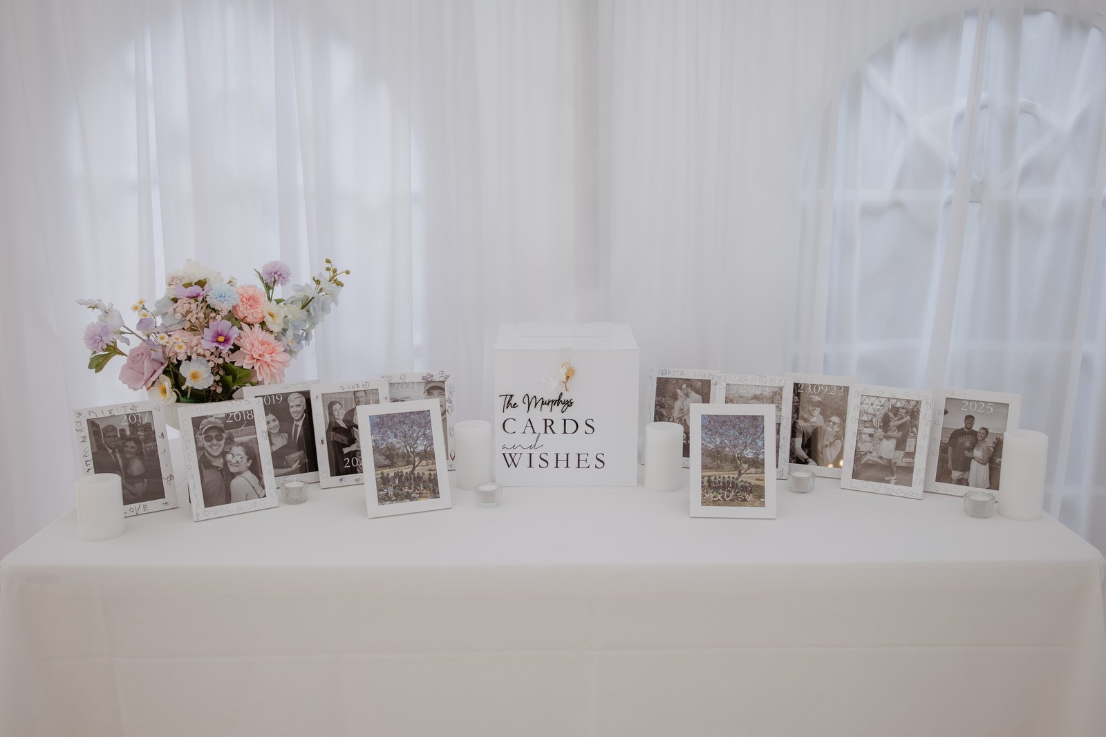 Cards and wishes table styled with a personalised sign, silk florals and candles
