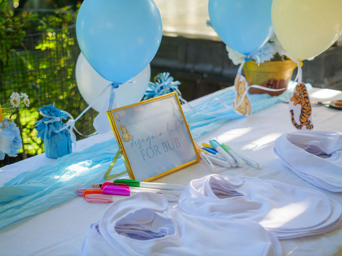 Guest tables styled with pastel bud vases, candles and warm fairy lights